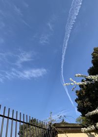 Low angle view of vapor trail against blue sky