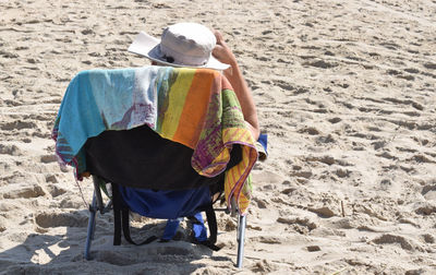 Rear view of man sitting on beach