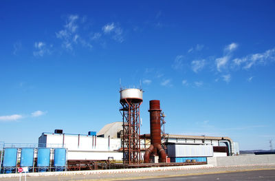 Water tower against blue sky