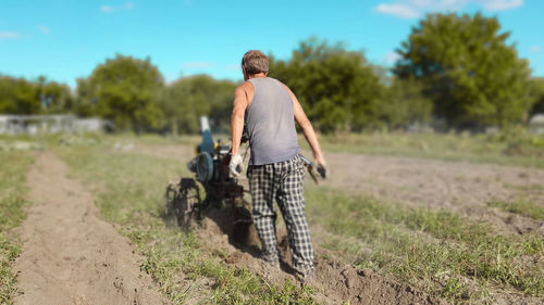 Rear view of man standing on field