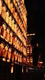 Illuminated city against sky at night