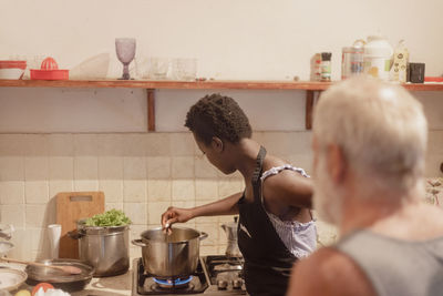 Side view of boy preparing food at home