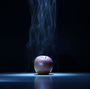 Close-up of apple on table against black background