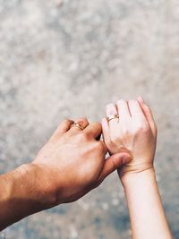 Cropped hands of couple wearing rings