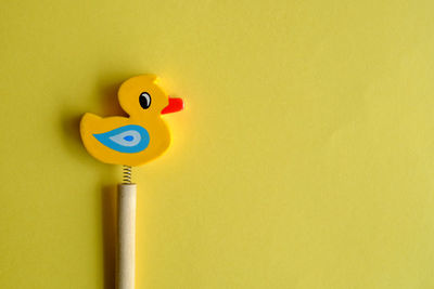 Close-up of toy over yellow background