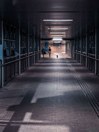 Rear view of man walking in tunnel