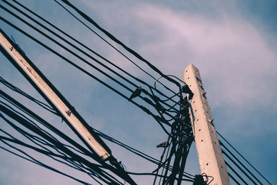 Low angle view of electricity pylon against sky