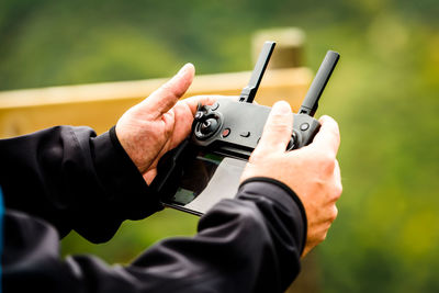 Close-up of man holding camera