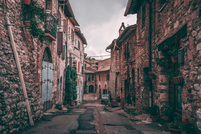 Narrow alley amidst old buildings in city