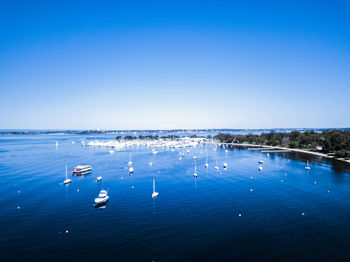 Scenic view of sea against clear blue sky
