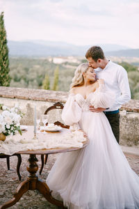 Rear view of couple holding hands