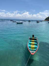 A boat with fish underneath at jetty perhentian island 