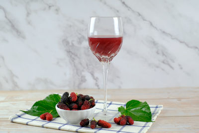 Red berries in glass on table