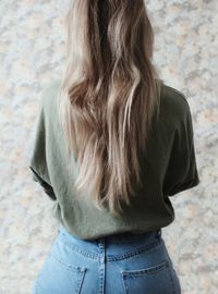 Rear view of woman standing against wall