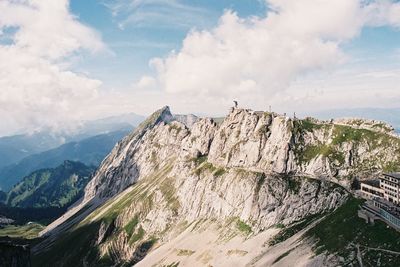 Scenic view of rocky mountains against cloudy sky