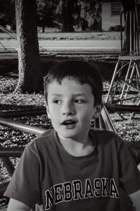 High angle view of boy looking away by play equipment at park