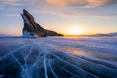 Scenic view of frozen sea against sky during sunset