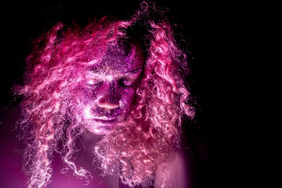 Close-up of pink lights against black background