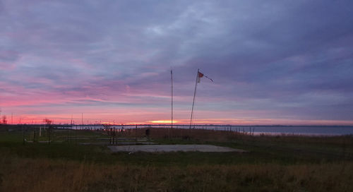 Scenic view of field against sky during sunset