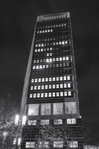 Low angle view of illuminated building against sky at night