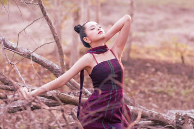 Young woman looking at camera in forest