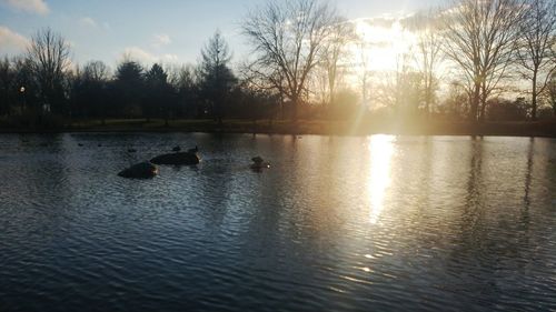 Scenic view of lake against sky during sunset