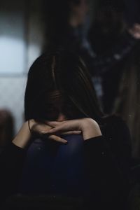 Close-up portrait of depressed woman at home