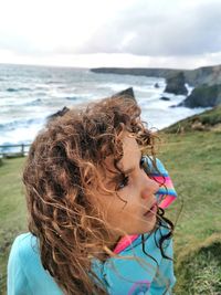 Thoughtful girl against sea