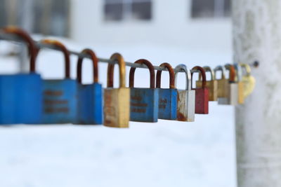 Close-up of padlocks hanging on railing