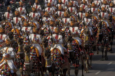 People sitting on royal elephants during parade