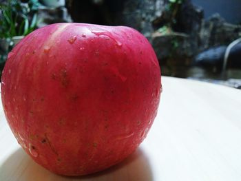Close-up of red apple on table