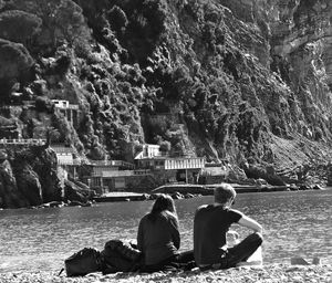 Rear view of woman sitting on bench