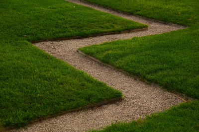 High angle view of garden path amidst grass in park