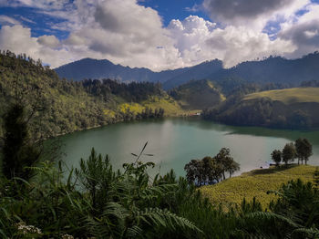 Scenic view of lake and mountains against sky