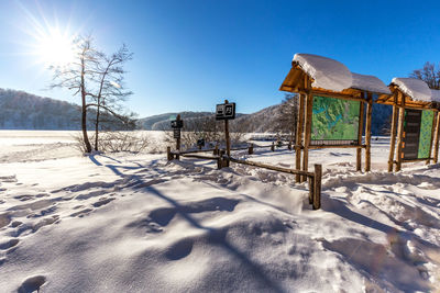 Snow covered field against sky