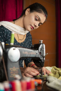 Side view of young man working at workshop