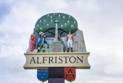 Low angle view of information sign against sky