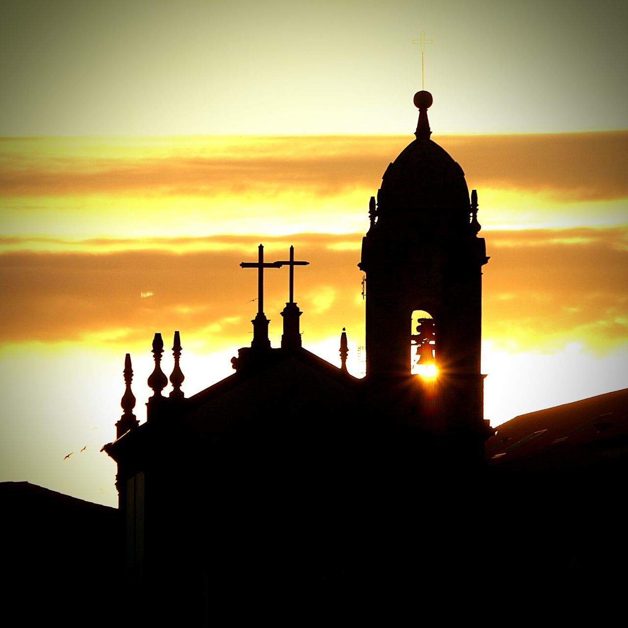 LOW ANGLE VIEW OF SILHOUETTE BELL TOWER AGAINST SKY