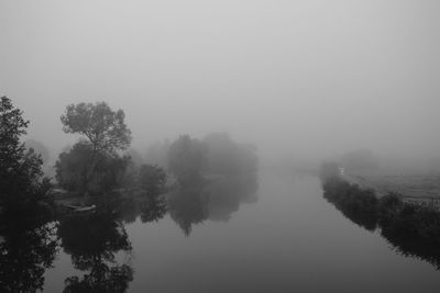 Scenic view of lake with trees in background