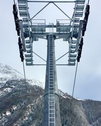 Low angle view of ski lit tower on snowcapped mountain