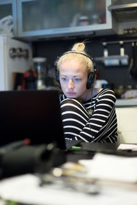Businesswoman working on laptop sitting at home