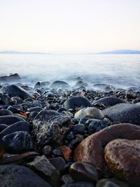 Rocks on beach against sky