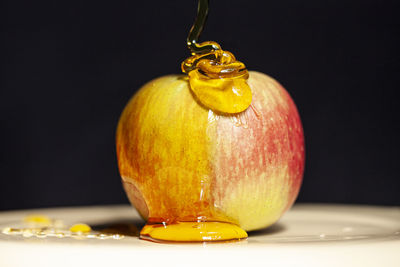 Close-up of apple on table against black background