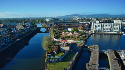 High angle view of river amidst buildings in city against sky