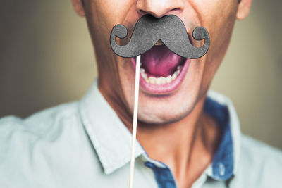 Close-up of man with mustache prop