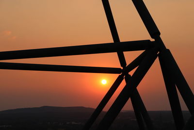 Silhouette bridge against sky during sunset