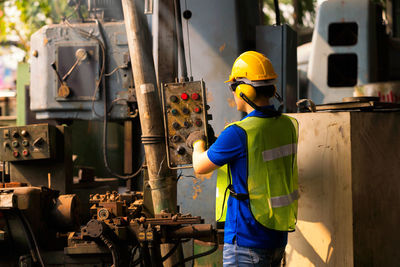 Rear view of man working