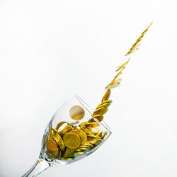 Close-up of yellow glass over white background