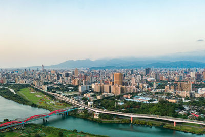 High angle view of river amidst buildings in city against sky