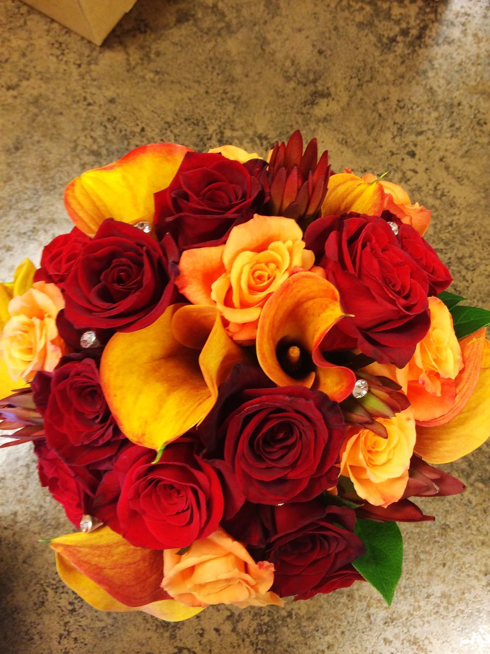 flower, indoors, petal, freshness, multi colored, rose - flower, flower head, yellow, fragility, high angle view, bouquet, vase, variation, rose, beauty in nature, table, close-up, flower arrangement, no people, still life